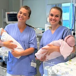 Two employess at department of nweborn intensive care with babies in their arms